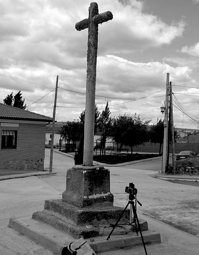 Fig. 1 – View of the votive cross showing the epigraph on the base plinth and the Kiev 88 camera used in the survey.