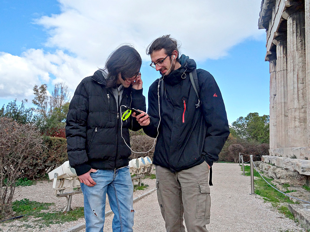 Fig. 5 – A pair of friends experiencing together the stories near the temple of Hephaistus, during the evaluation of the prototype at the Ancient Agora.